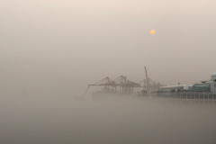 Sunrise over a city choked in smoke